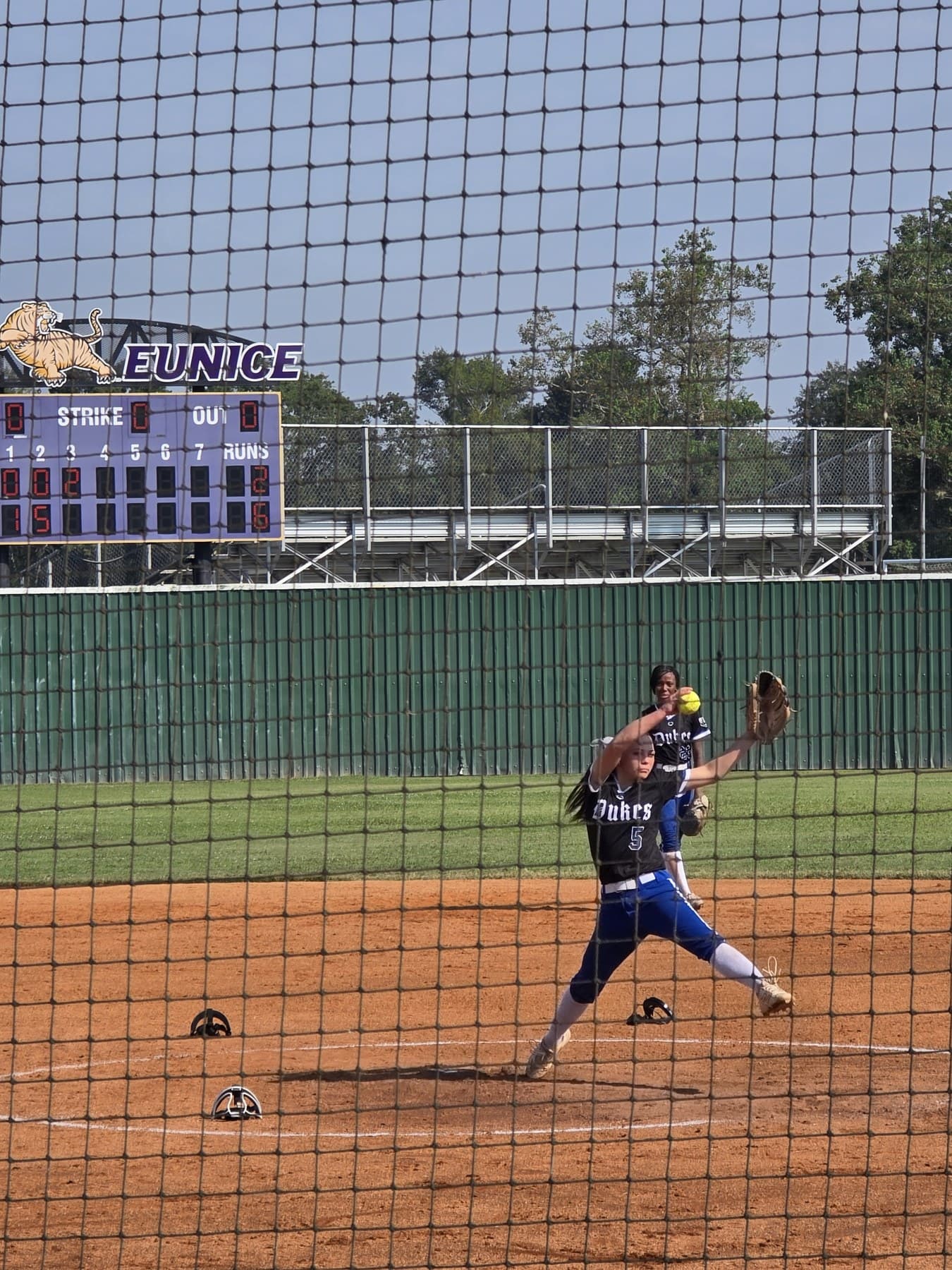 Alexis Arnold firing a pitch from the circle in her Lady Dukes uniform.