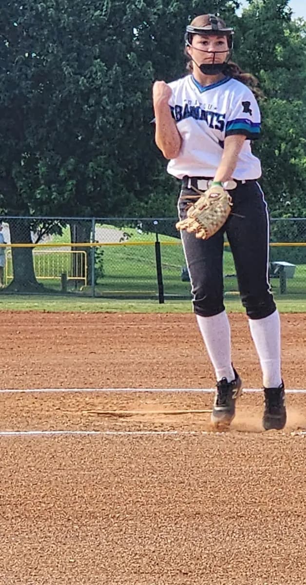 Alexis Arnold set to pitch, ball in glove, 2024 season.